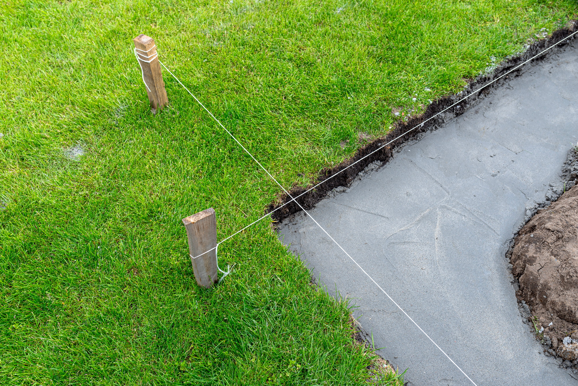 Foundation footings poured in a ditch in the yard, building a terrace in the backyard.